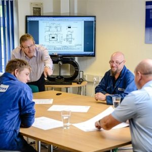 Team overviewing technical drawings