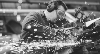 person using angle grinder on winch